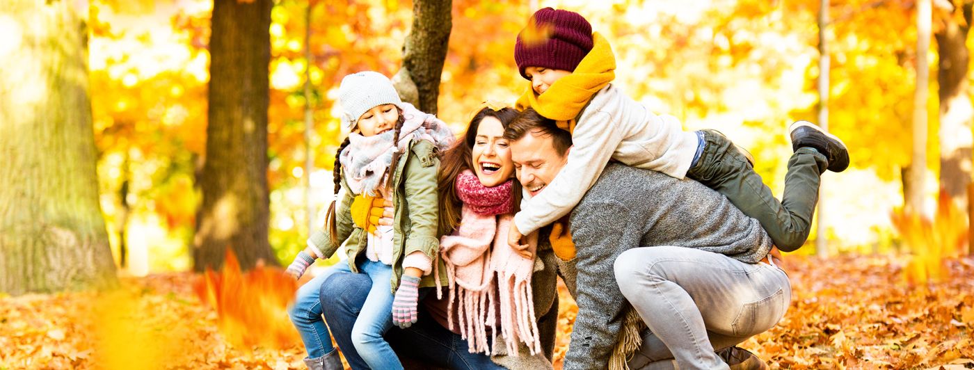 Eine glückliche Familie in einem herbstlichen Wald.